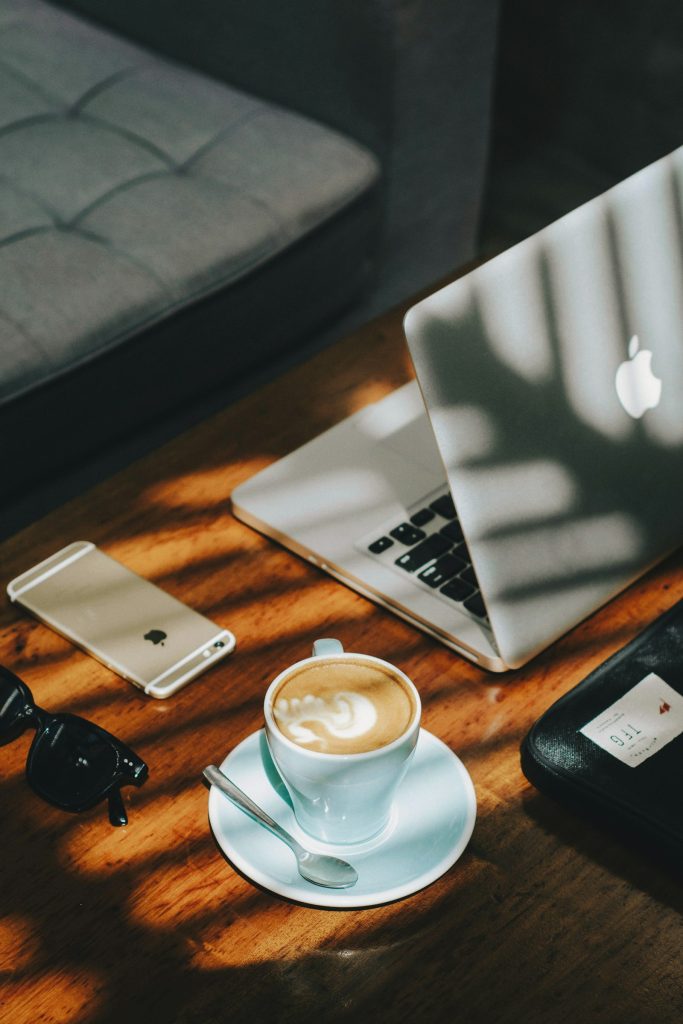 Small business owner checking a website checklist on a laptop and phone
